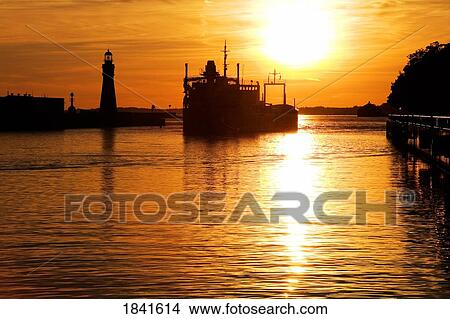 Picture - Buffalo Lighthouse And Cement Carrier In Buffalo Port At Sunset; Buffalo, New York State, Usa. Fotosearch