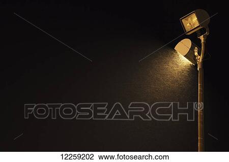 Bugs create light streaks around a floodlight; Georgetown, Ontario, Canada View Large Photo Image Stock Image - Bugs create light streaks around a floodlight; Georgetown, Ontario, Canada. Fotosearch
