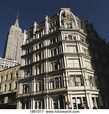 Building Facade With Empire State Building In Background, Manhattan, New York, Usa View Large Photo Image Stock Photo - Building Facade With Empire State Building In Background, Manhattan, New York, Usa. Fotosearch