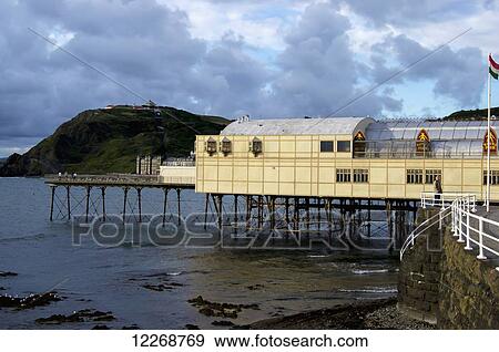 Stock Photo - Building on stilts at the water's edge; Aberystwyth, Ceredigion, Wales. Fotosearch