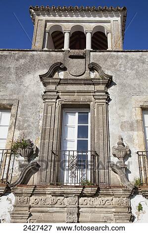 Stock Photo - Building with ornate facade and columns on top floor; Arcos de la Frontera, Andalusia, Spain. Fotosearch