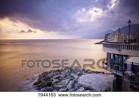 Stock Image - Buildings Along The Coast At Sunset; Camogli Liguria Italy. Fotosearch