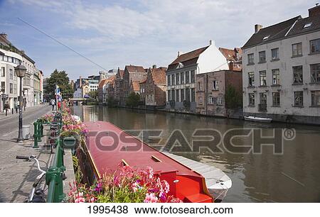 Buildings Along The Riverside And A Boat Mooring; Ghent Oost-Vlaanderen Belgium View Large Photo Image Stock Photo - Buildings Along The Riverside And A Boat Mooring; Ghent Oost-Vlaanderen Belgium. Fotosearch
