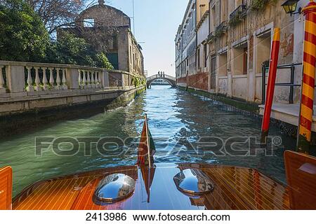Buildings along the shoreline of a canal viewed from a boat; Venice, Veneto, Italy View Large Photo Image Stock Photograph - Buildings along the shoreline of a canal viewed from a boat; Venice, Veneto, Italy. Fotosearch