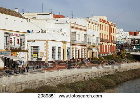 Stock Image - Buildings Along The Shoreline Of The River; Chiclana De La Frontera, Andalusia, Spain. Fotosearch
