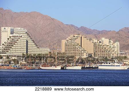 Stock Photo - Buildings Along The Water And Boats In The Harbour; Jordan Israel. Fotosearch