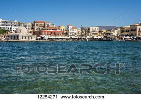 Stock Image - Buildings along Venetian harbour; Chania, Crete, Greece. Fotosearch