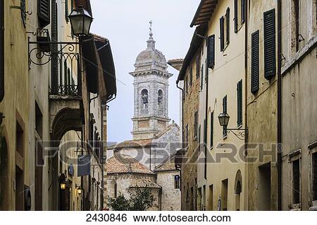 Stock Photograph - Buildings and a bell tower; San Quirico d'Orcia, Tuscany, Italy. Fotosearch
