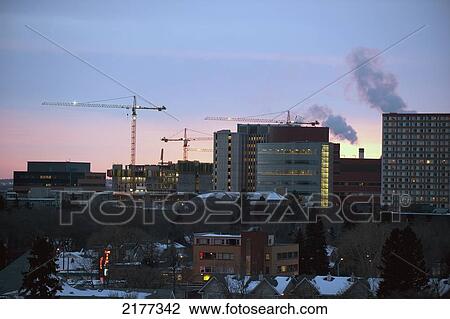 Stock Image - Buildings And Cranes In The Skyline At Dusk; Edmonton Alberta Canada. Fotosearch