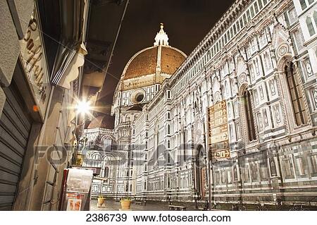 Stock Photo - Buildings and Florence Cathedral illuminated a nighttime; Florence, Tuscany, Italy. Fotosearch