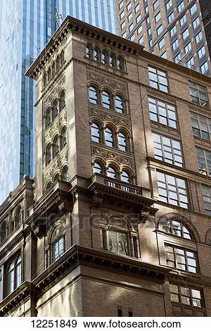 Stock Photo - Buildings and skyscrapers contrasting old and modern; New York City, New York, United States of America. Fotosearch
