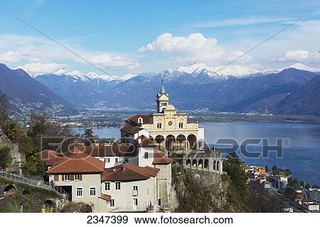 Buildings And The Swiss Alps Along Lake Maggiore; Locarno, Ticino, Switzerland View Large Photo Image Stock Photo - Buildings And The Swiss Alps Along Lake Maggiore; Locarno, Ticino, Switzerland. Fotosearch