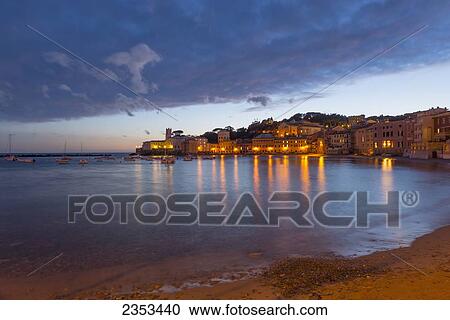 Buildings Illuminated At Night Along The Water's Edge In Cinque Terre; Sestri Levante, Ligurian, Italy View Large Photo Image Stock Image - Buildings Illuminated At Night Along The Water's Edge In Cinque Terre; Sestri Levante, Ligurian, Italy. Fotosearch