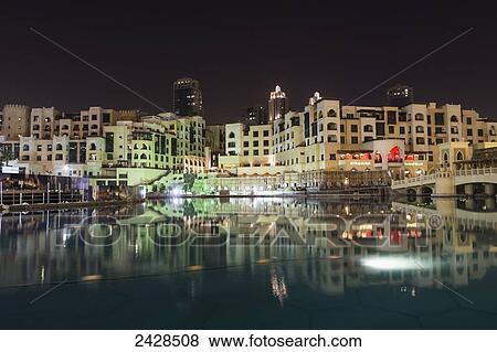 Buildings illuminated at nighttime and reflected in the tranquil water; Dubai, United Arab Emirates View Large Photo Image Stock Photo - Buildings illuminated at nighttime and reflected in the tranquil water; Dubai, United Arab Emirates. Fotosearch