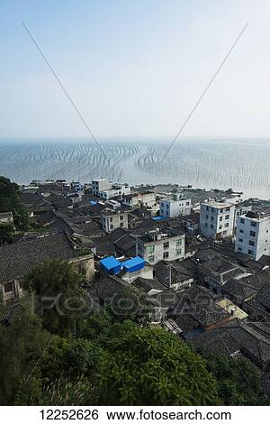 Stock Photograph - Buildings in a fishing village along the coast; Xiapu, Fujian, China. Fotosearch