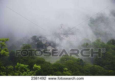 Buildings in a village barely visible through the heavy fog; Corippo, Ticino, Switzerland View Large Photo Image Stock Image - Buildings in a village barely visible through the heavy fog; Corippo, Ticino, Switzerland. Fotosearch