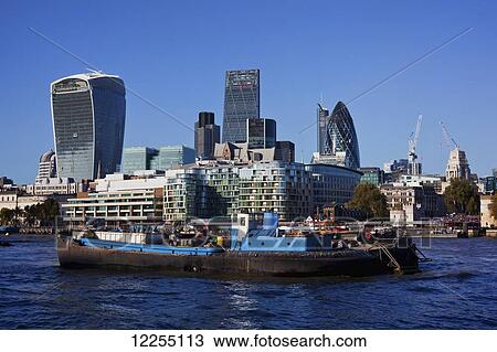 Stock Image - Buildings of the City of London, the financial district, with the River Thames; London, England. Fotosearch