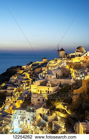 Buildings on a hillside illuminated at dusk; Oia, Santorini, Greece View Large Photo Image Stock Image - Buildings on a hillside illuminated at dusk; Oia, Santorini, Greece. Fotosearch