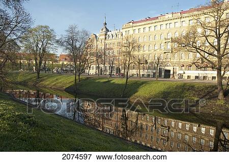 Stock Photo - Buildings Reflected In The Pilsetas Canal, Riga, Latvia. Fotosearch