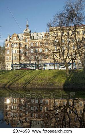 Buildings Reflected In The Pilsetas Canal, Riga, Latvia View Large Photo Image Stock Photo - Buildings Reflected In The Pilsetas Canal, Riga, Latvia. Fotosearch