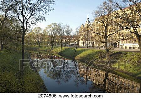 Stock Photograph - Buildings Reflected In The Pilsetas Canal, Riga, Latvia. Fotosearch