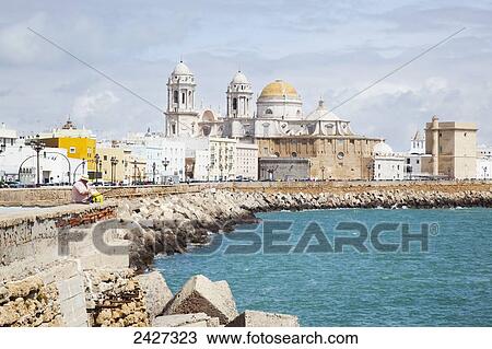 Stock Image - Buildings viewed from the water's edge; Cadiz, Andalusia, Spain. Fotosearch