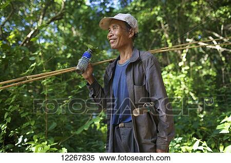 Bunong man going fishing; Mondulkiri, Cambodia View Large Photo Image Stock Photography - Bunong man going fishing; Mondulkiri, Cambodia. Fotosearch