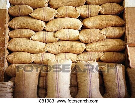 Stock Image - Burlap Sacks Stacked Up In A Nutmeg Factory. Fotosearch