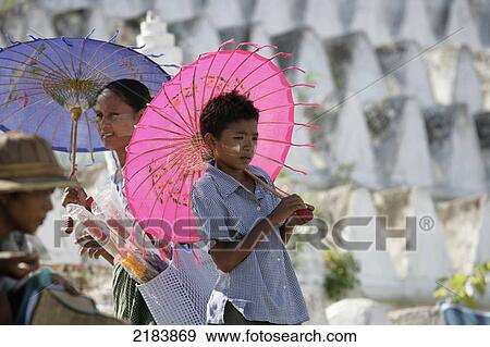 Stock Photo - Burma, Local people with parasols in front of stupas; Mingun. Fotosearch