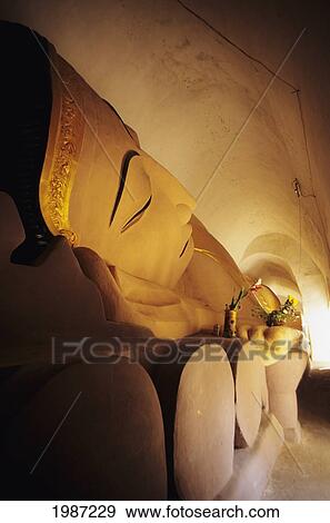 Burma (Myanmar), Bagan, Close-up view of reclining Buddha; Manuha Paya View Large Photo Image Stock Photo - Burma (Myanmar), Bagan, Close-up view of reclining Buddha; Manuha Paya. Fotosearch