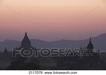 Stock Photo - Burma (Myanmar), Bagan, Silhouetted temples at sunset.. Fotosearch