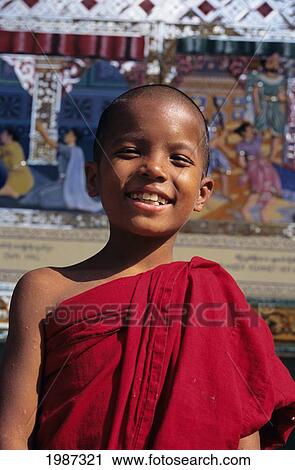 Burma (Myanmar), Bago, Shwethalyaung Paya, Portrait Of Smiling Young Monk In Temple, Painted Reliefs In Background. Editorial Use Only. View Large Photo Image Stock Image - Burma (Myanmar), Bago, Shwethalyaung Paya, Portrait Of Smiling Young Monk In Temple, Painted Reliefs In Background. Editorial Use Only.. Fotosearch