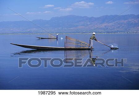 Burma (Myanmar), Inle Lake, Fishermen On Long Flat Boats, Reflections On Water. View Large Photo Image Stock Photography - Burma (Myanmar), Inle Lake, Fishermen On Long Flat Boats, Reflections On Water.. Fotosearch