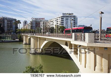 Stock Photo - Bus On Bridge Over The Guadalquivir River; Seville Spain. Fotosearch