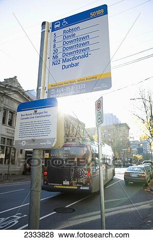 Stock Photo - Bus Stop With Bus Just Pulling Away From It; Vancouver, British Columbia, Canada. Fotosearch