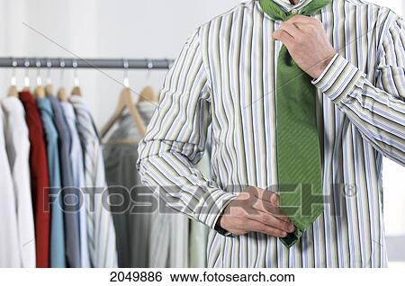 Businessman Putting On Tie View Large Photo Image Stock Photograph - Businessman Putting On Tie. Fotosearch