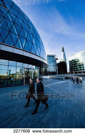 Businessmen walk outside famous London landmarks; London, England View Large Photo Image Stock Photo - Businessmen walk outside famous London landmarks; London, England. Fotosearch