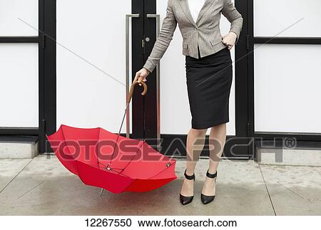 Businesswoman with a red umbrella; Abbotsford, British Columbia, Canada View Large Photo Image Stock Image - Businesswoman with a red umbrella; Abbotsford, British Columbia, Canada. Fotosearch
