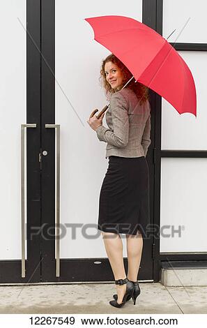 Businesswoman with a red umbrella; Abbotsford, British Columbia, Canada View Large Photo Image Stock Photo - Businesswoman with a red umbrella; Abbotsford, British Columbia, Canada. Fotosearch