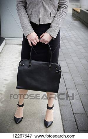 Stock Photo - Businesswoman with case; Abbotsford, British Columbia, Canada. Fotosearch