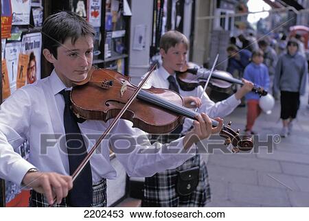 Stock Image - Buskers Along Royal Mile During Fringe Festival Edinburgh, Scotland. Fotosearch