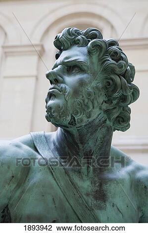 Stock Image - Bust Of Bronze Man Statue; Paris, France. Fotosearch
