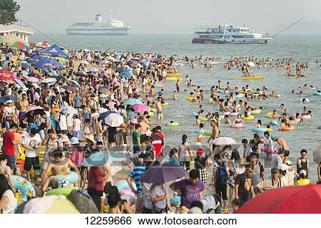 Stock Photograph - Busy seaside with boats in the Taiwan Strait; Xiamen, Fujian, China. Fotosearch