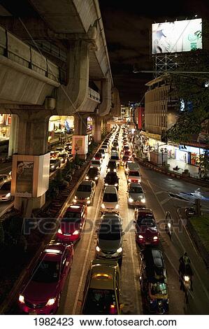 Stock Image - Busy Street At Night; Bangkok Thailand. Fotosearch