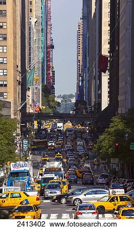 Busy street in Manhattan with yellow taxis and traffic; New York City, New York, United States of America View Large Photo Image Stock Image - Busy street in Manhattan with yellow taxis and traffic; New York City, New York, United States of America. Fotosearch