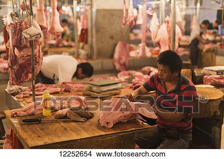 Butcher in a market; Xiapu, Fujian, China View Large Photo Image Picture - Butcher in a market; Xiapu, Fujian, China. Fotosearch