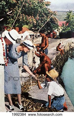 Picture - C. 1935 Tourist Advertisement, Caucasion Couple Talking To Young Local Boy.. Fotosearch