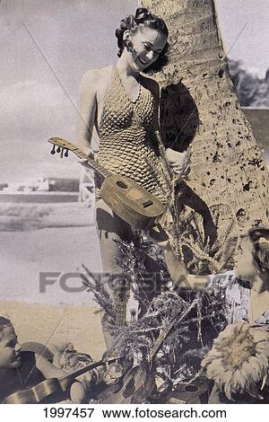 C. 1938 Hawaii, Three Girls On Beach With Ukuleles Under Palm Tree View Large Photo Image Stock Photo - C. 1938 Hawaii, Three Girls On Beach With Ukuleles Under Palm Tree. Fotosearch