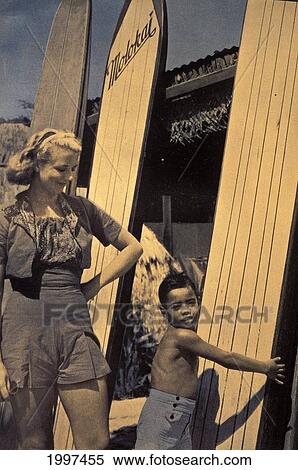 C. 1938 Hawaii, Woman Tourist With Local Boy, Longboard Molokai Surfboards View Large Photo Image Stock Photography - C. 1938 Hawaii, Woman Tourist With Local Boy, Longboard Molokai Surfboards. Fotosearch