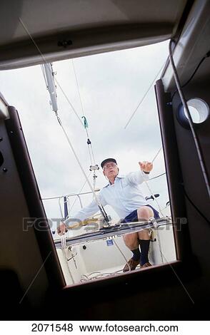 Stock Photo - Cabin View Of Senior Man Sailing. Fotosearch